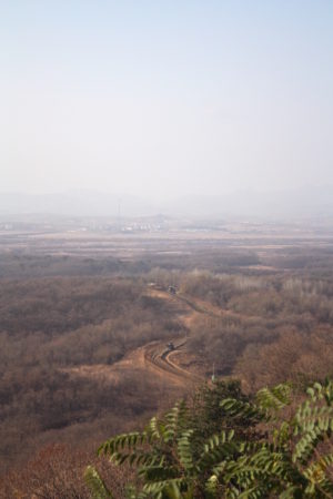 Der Grenzstreifen zwischen Nord- und Südkorea von einem UN-Aussichtsturm aus, mit Blick auf die nordkoreanische Propagandastadt mit Fahnenmast im Hintergrund © BQ/Warnecke